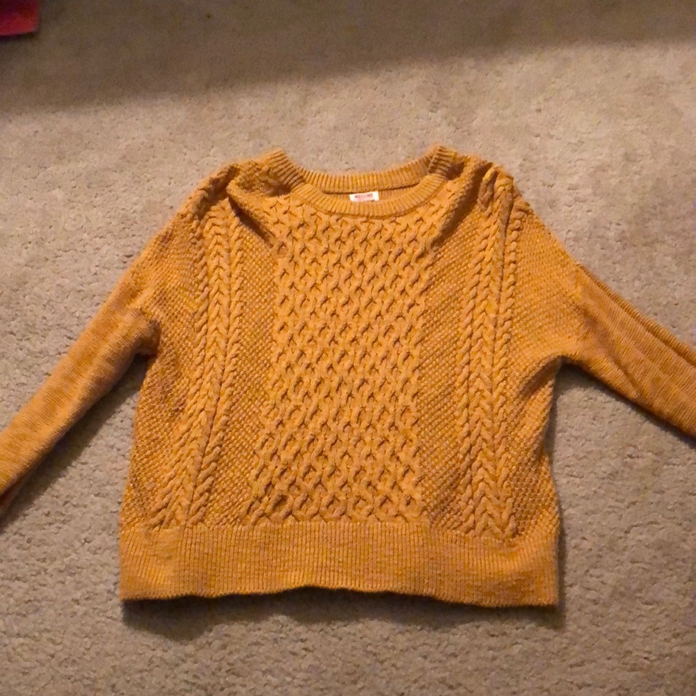 a mustard yellow sweater